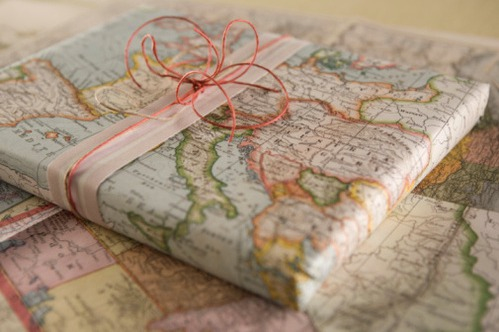 old maps used as wrapping paper on gifts with a little bit of white and red ribbon to finish the look.